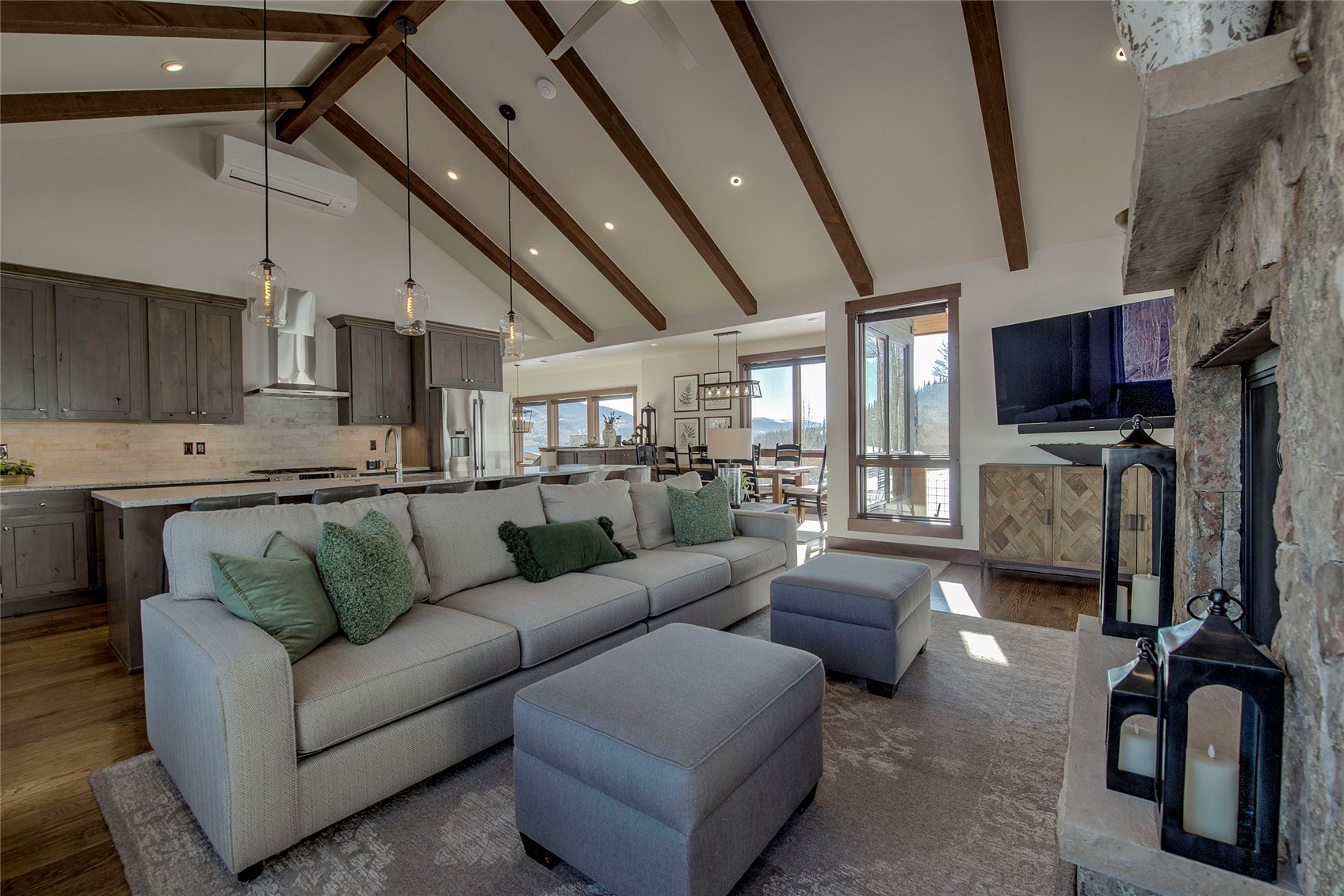 Living area featuring high vaulted ceiling, a fireplace, recessed lighting, a wall unit AC, and beamed ceiling