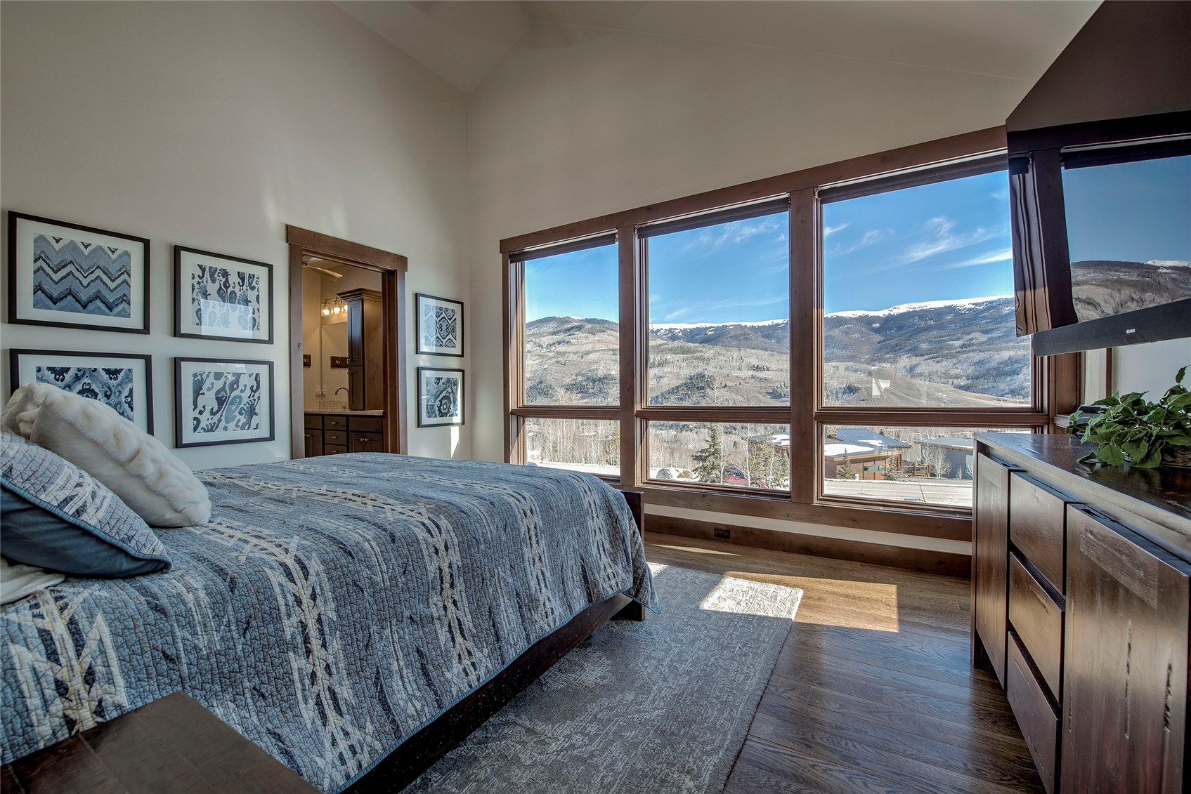 307 Maryland Creek Road Silverthorne, CO 80498 - Photo 11 of 47 Primary bedroom featuring vaulted ceilings and large windows with 270 degree mountain views