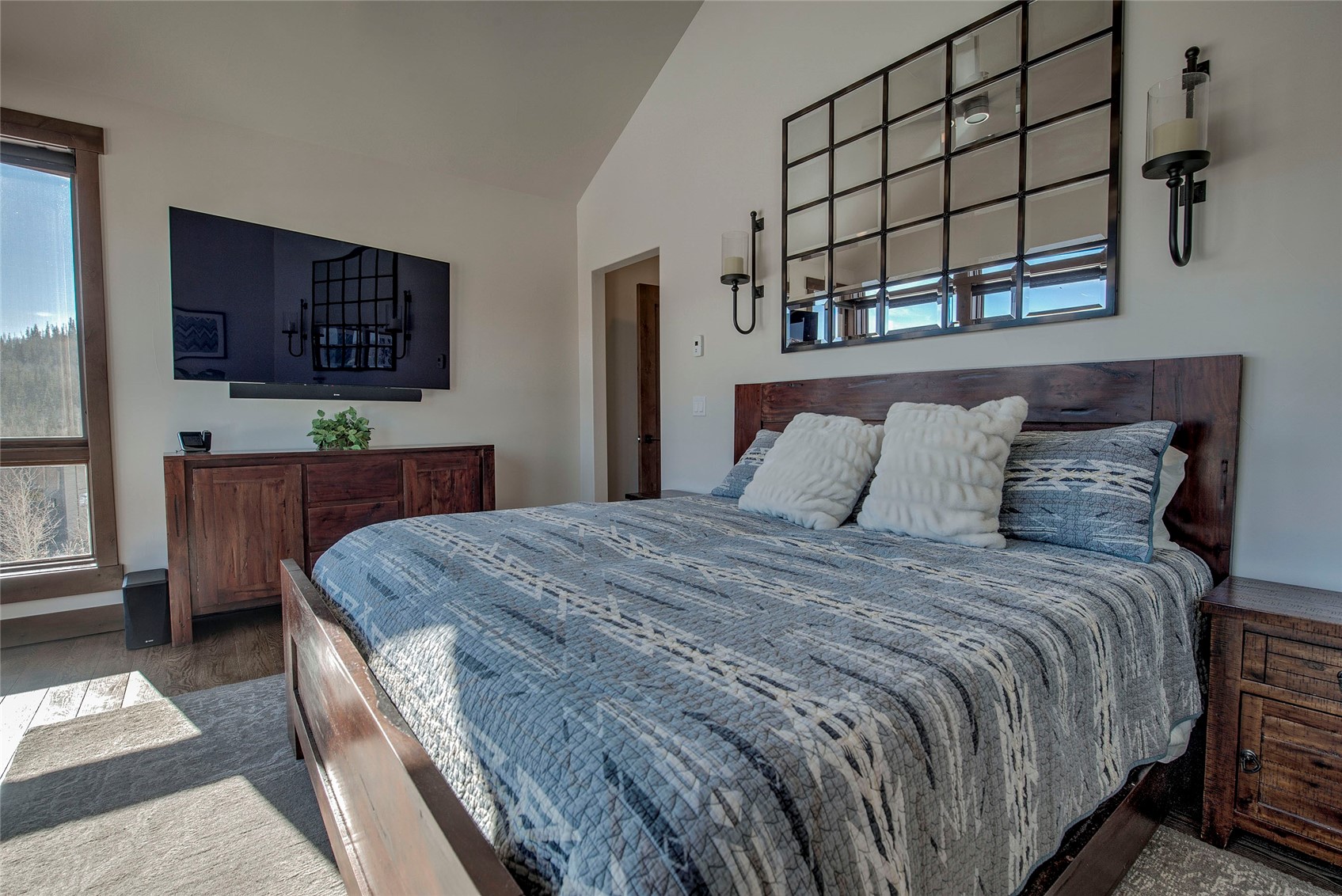307 Maryland Creek Road Silverthorne, CO 80498 - Photo 12 of 47 Primary bedroom featuring vaulted ceilings and large windows with 270 degree mountain views