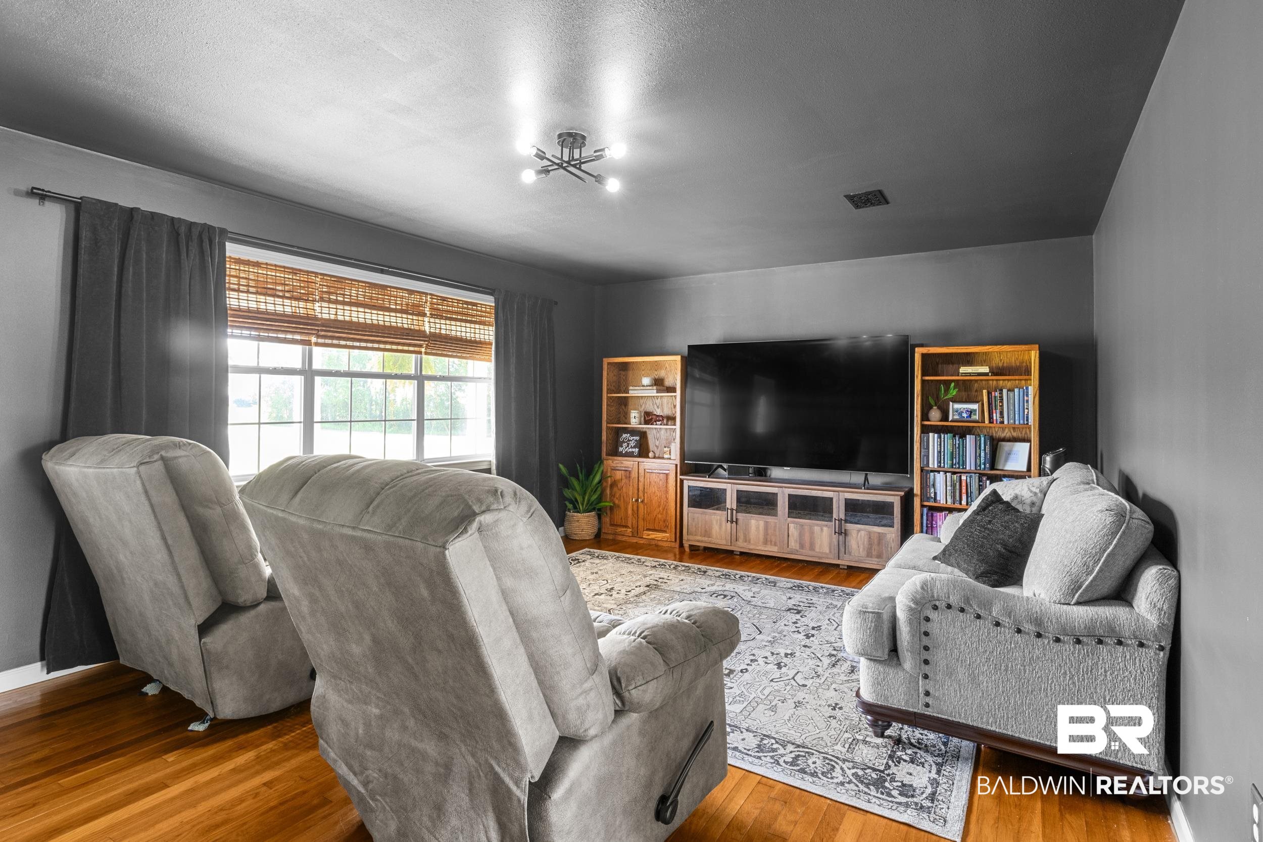 17689 Brewer Road Foley, AL 36535 - Photo 31 of 54 Living room featuring a notable chandelier, wood-type flooring, and a textured ceiling