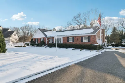 a front view of a house with a yard and chandelier