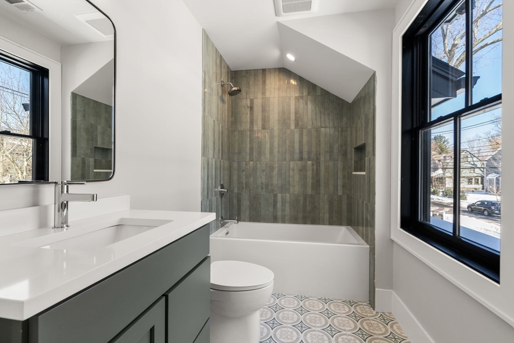 577 Grove Street Newton, MA 02462 - Photo 17 of 29 a bathroom with a sink a toilet a bathtub and shower