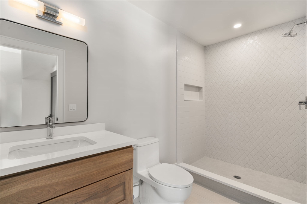 577 Grove Street Newton, MA 02462 - Photo 19 of 29 a bathroom with a sink a toilet and shower