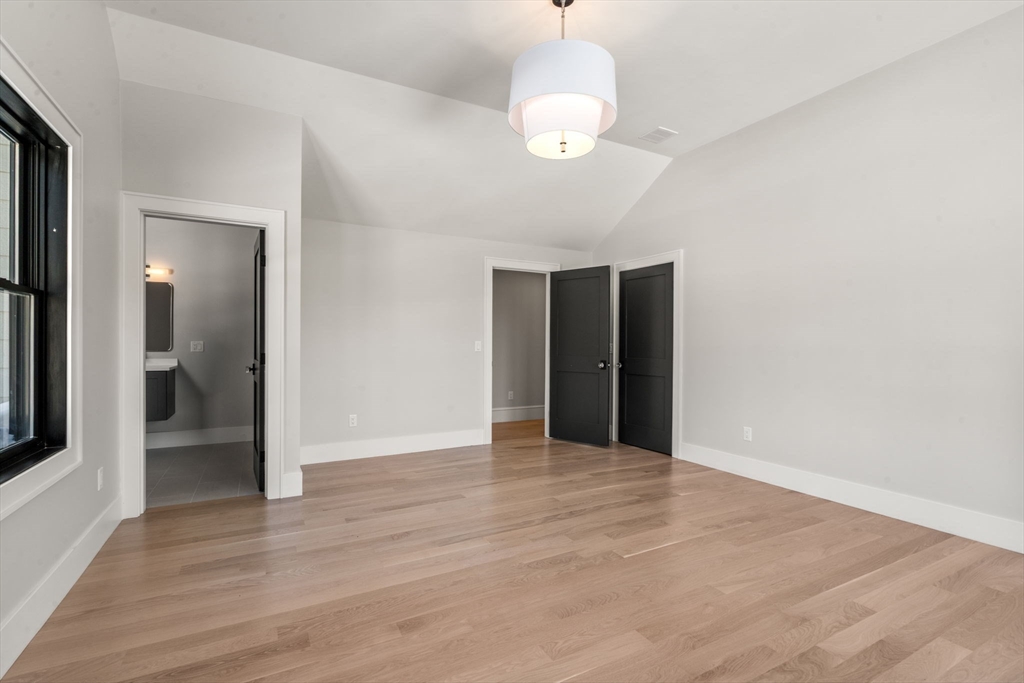 577 Grove Street Newton, MA 02462 - Photo 22 of 29 a view of an empty room with wooden floor and a mirror