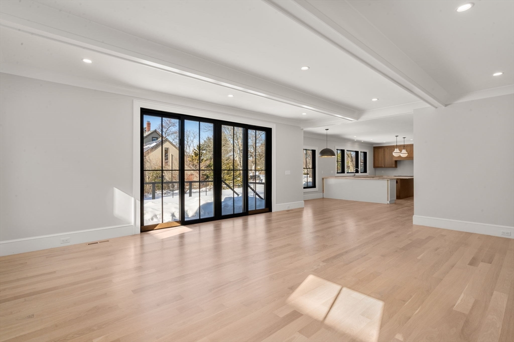 577 Grove Street Newton, MA 02462 - Photo 5 of 29 a view of an empty room with a window and wooden floor