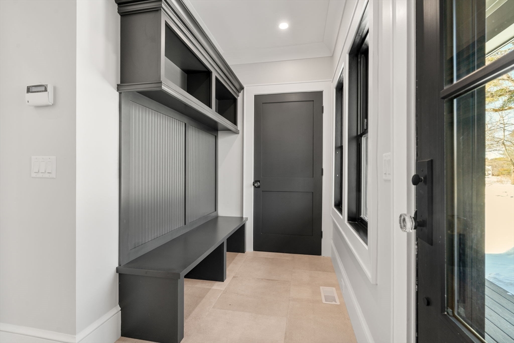 577 Grove Street Newton, MA 02462 - Photo 10 of 29 a kitchen with stainless steel appliances kitchen island a refrigerator and microwave