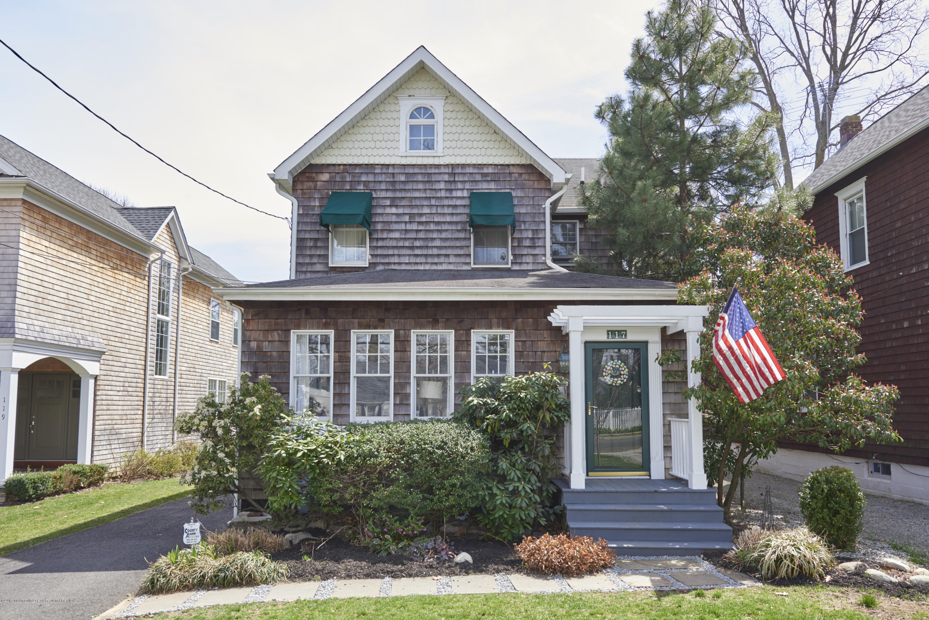 117 Black Point Road Rumson, NJ 07760 - Photo 1 of 34 a front view of a house with garden