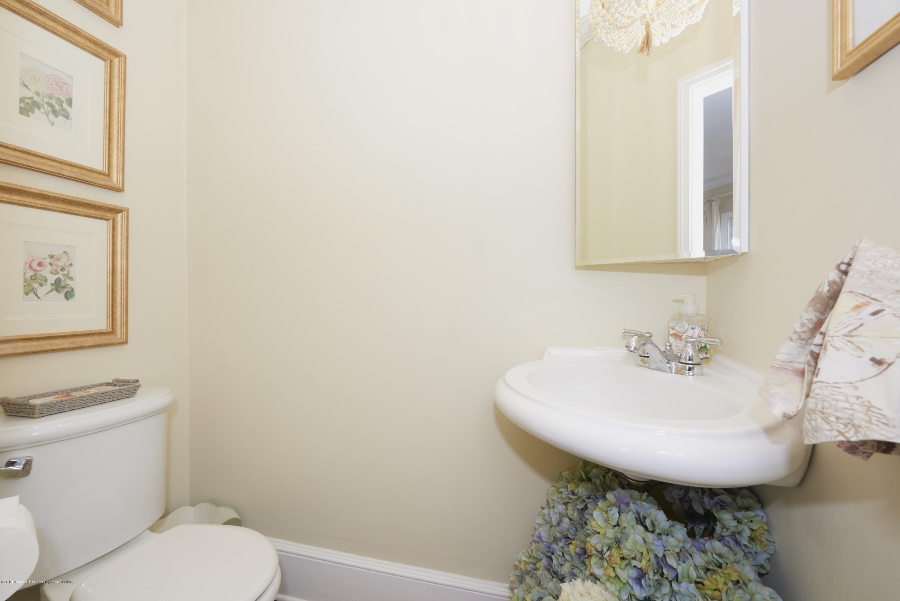 117 Black Point Road Rumson, NJ 07760 - Photo 6 of 34 a bathroom with a sink a toilet and mirror