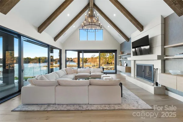 a living room with fireplace furniture and a floor to ceiling window