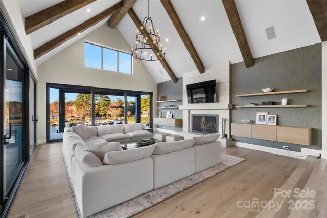 a living room with furniture a large window and a fireplace