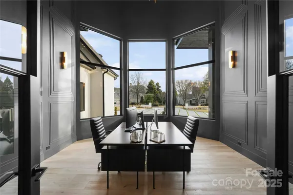a dining room with furniture a chandelier and wooden floor