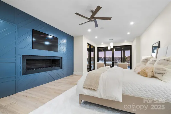 a spacious bedroom with a large bed and a ceiling fan