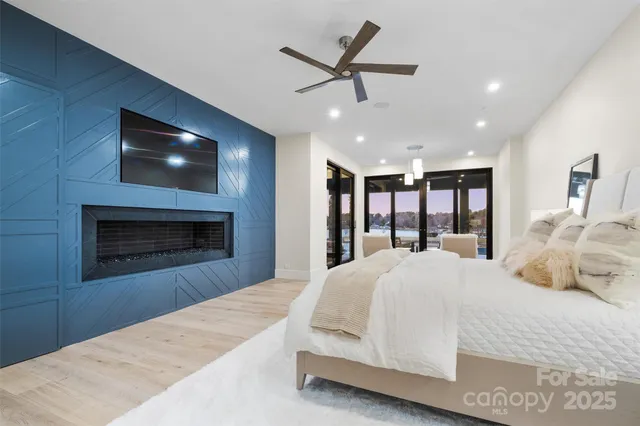 a spacious bedroom with a large bed and a ceiling fan