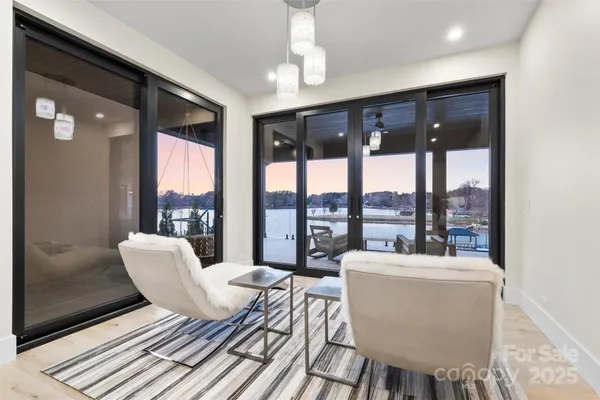 a living room with furniture and a floor to ceiling window