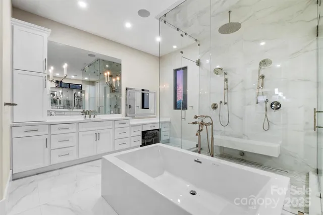 a large bathroom with a tub sink a vanity and mirrors