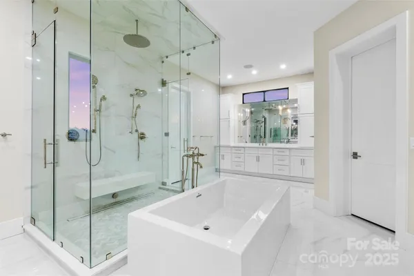 a bathroom with a shower sink and mirror