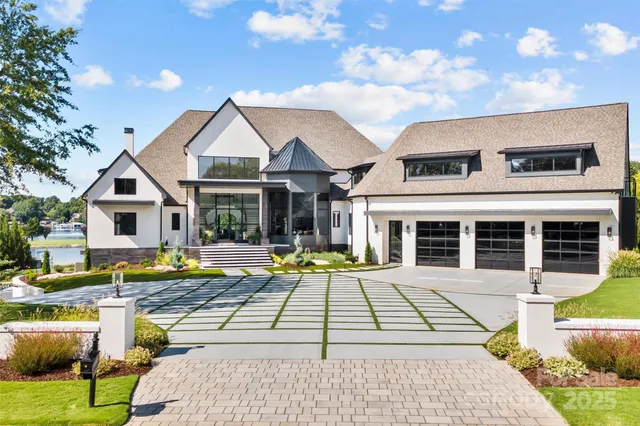 a view of a house with swimming pool and sitting area