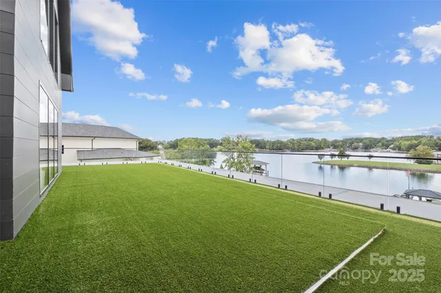 a living room with furniture and large windows