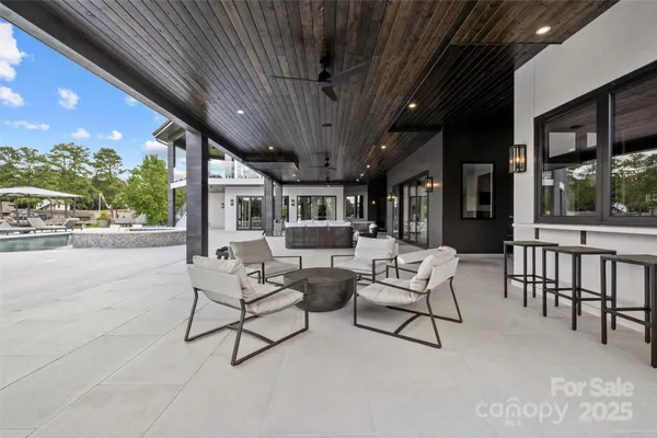 a living room with patio furniture and a potted plants