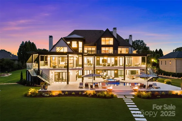 a front view of a house with garden and sitting area