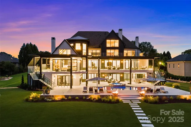 a front view of a house with garden and sitting area
