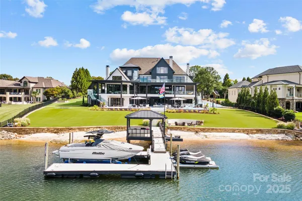an aerial view of a house with swimming pool garden and patio