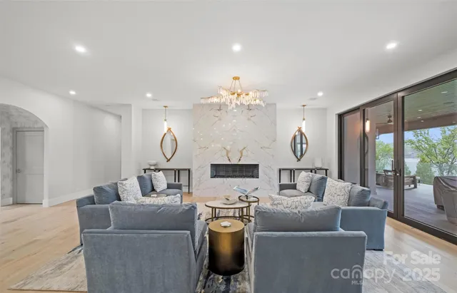 a living room with furniture and a chandelier