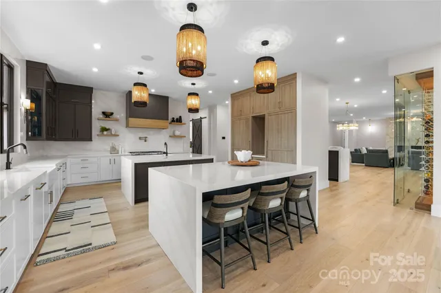 an open kitchen with a sink and breakfast area