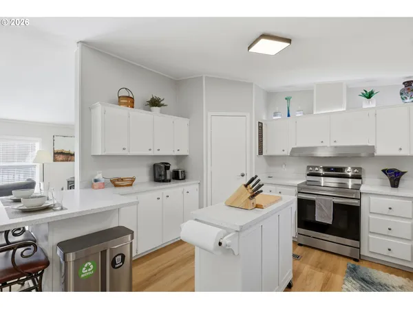 a kitchen with a sink stove and white cabinets