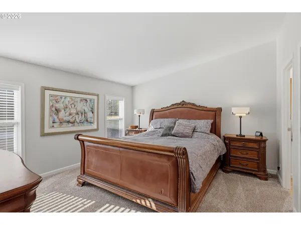 a bedroom with a bed and a painting on the wall