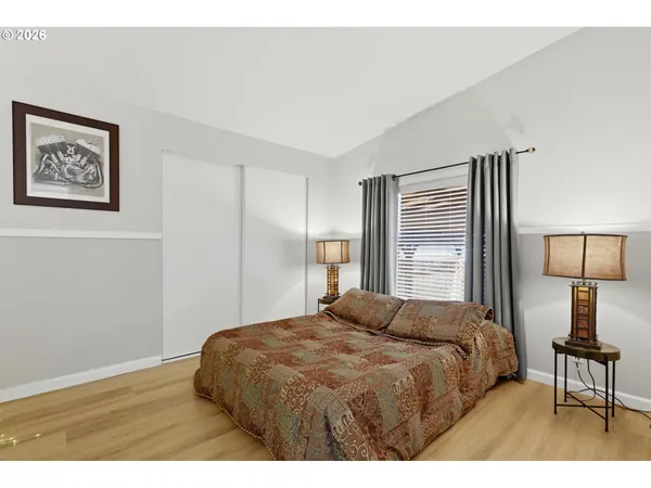 a bedroom with a bed and a lamp on table