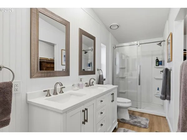 a bathroom with a sink mirror toilet and shower