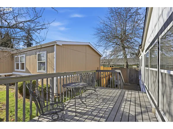 a view of a house with a wooden deck