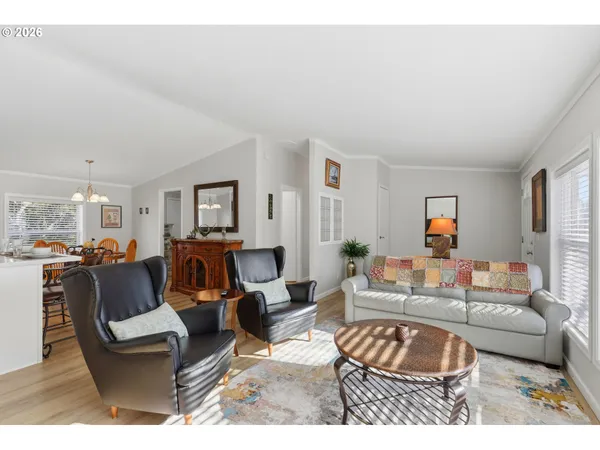 a living room with furniture a rug and a window
