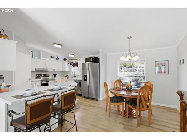 a view of a dining room with furniture and chandelier