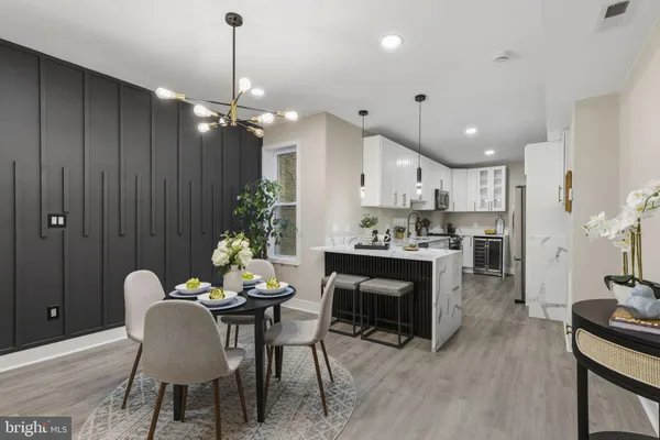 a dining room with furniture a chandelier and wooden floor