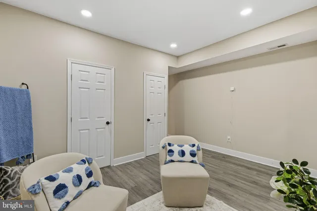 a bedroom with furniture and a wooden floor