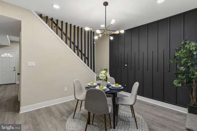 a view of a dining room with furniture and chandelier