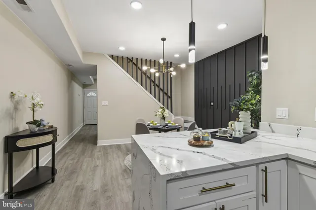 a kitchen with stainless steel appliances granite countertop grey cabinets a stove a sink and dishwasher