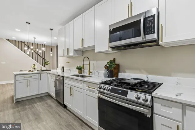 a kitchen with stainless steel appliances a refrigerator and a stove top oven