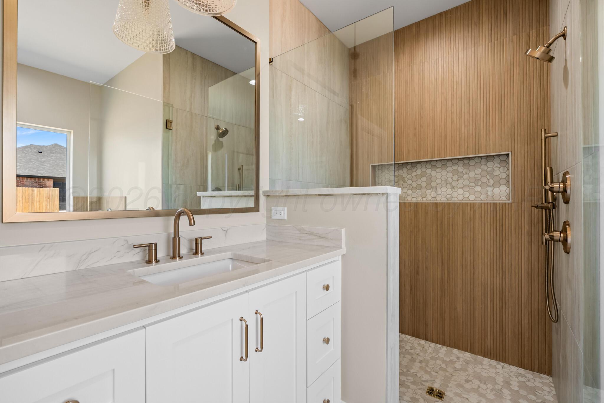 4201 Juniper Springs Road Amarillo, TX 79119 - Photo 19 of 27 a bathroom with a sink and a mirror