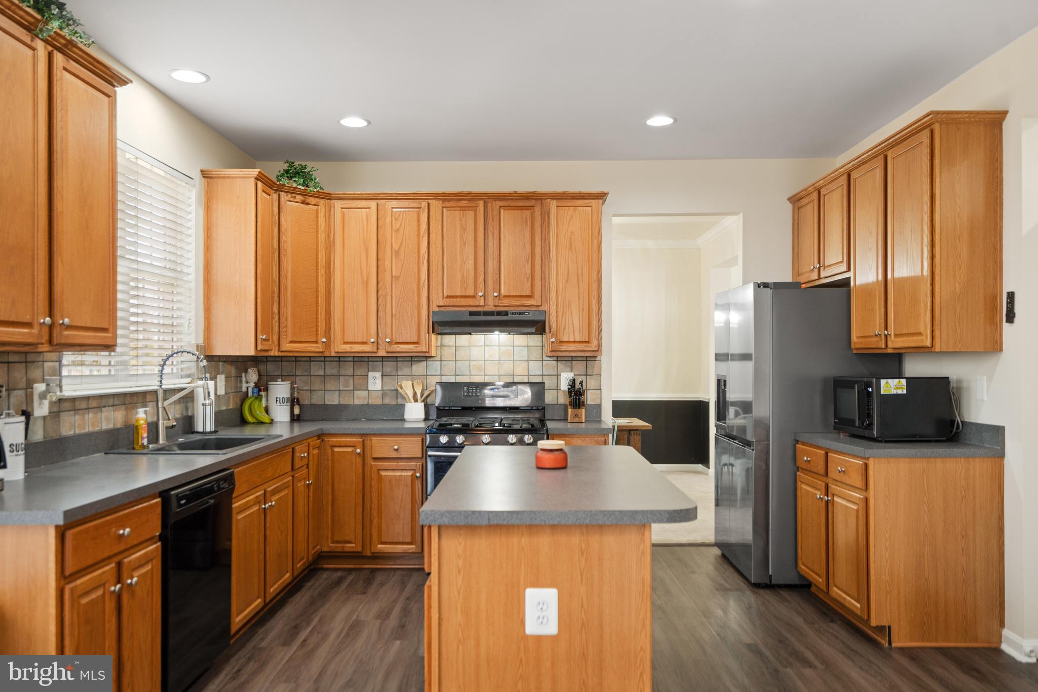 471 Blossom Tree Road Culpeper, VA 22701 - Photo 13 of 26 a kitchen with a sink a counter top space a large window and stainless steel appliances
