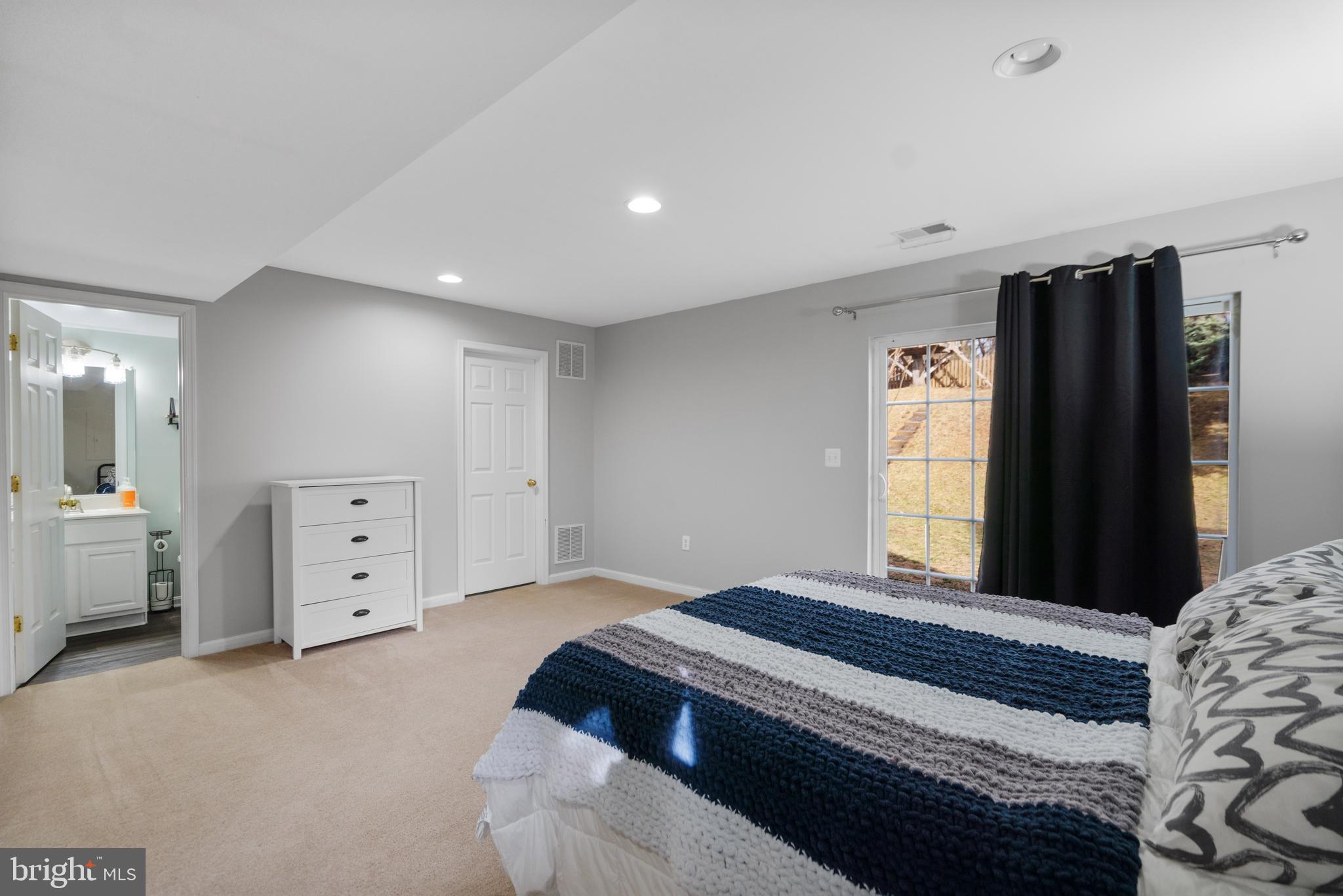471 Blossom Tree Road Culpeper, VA 22701 - Photo 21 of 26 a spacious bedroom with a large bed and a dresser