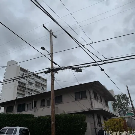 a view of a street with a building and mountain view