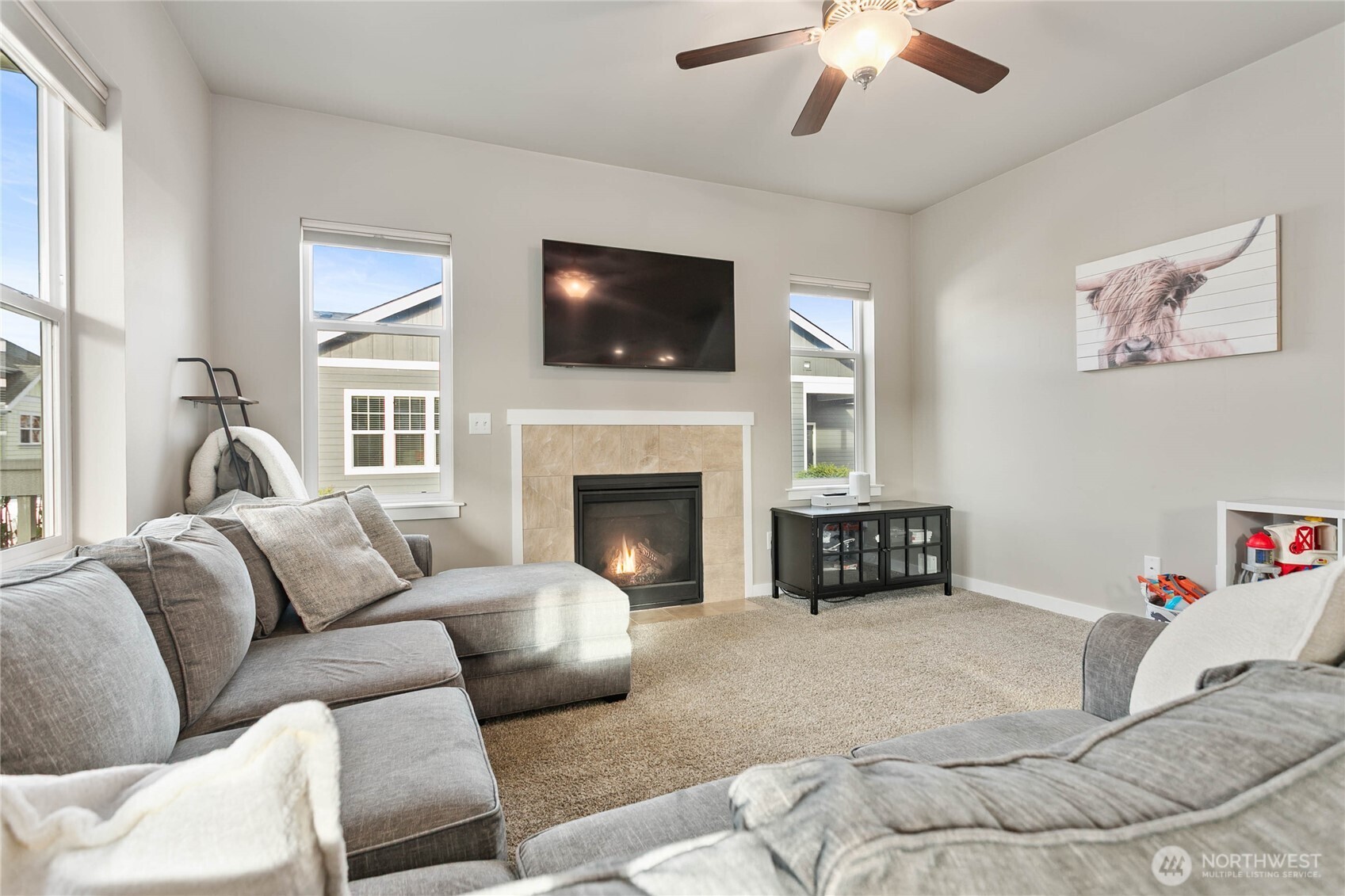 1970 North Prairie Lane Lynden, WA 98264 - Photo 12 of 40 a living room with furniture a flat screen tv and a fireplace