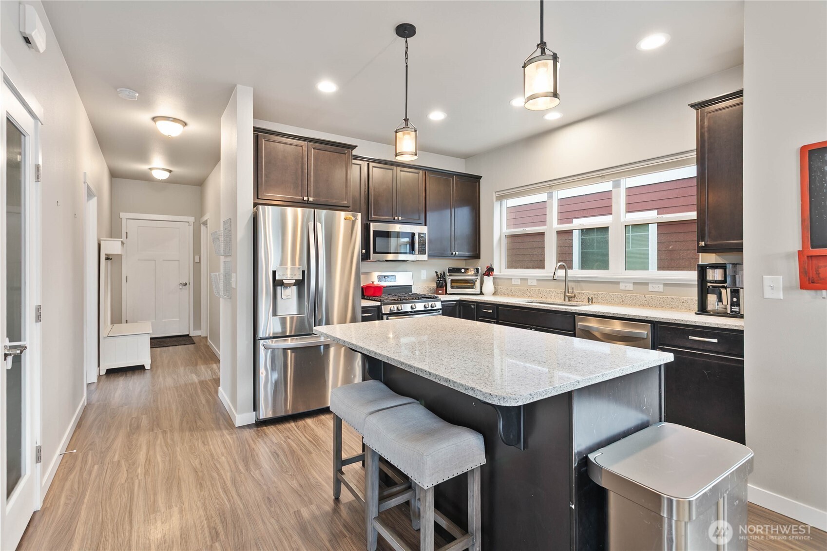 1970 North Prairie Lane Lynden, WA 98264 - Photo 15 of 40 a kitchen with stainless steel appliances a dining table chairs stove refrigerator and cabinets