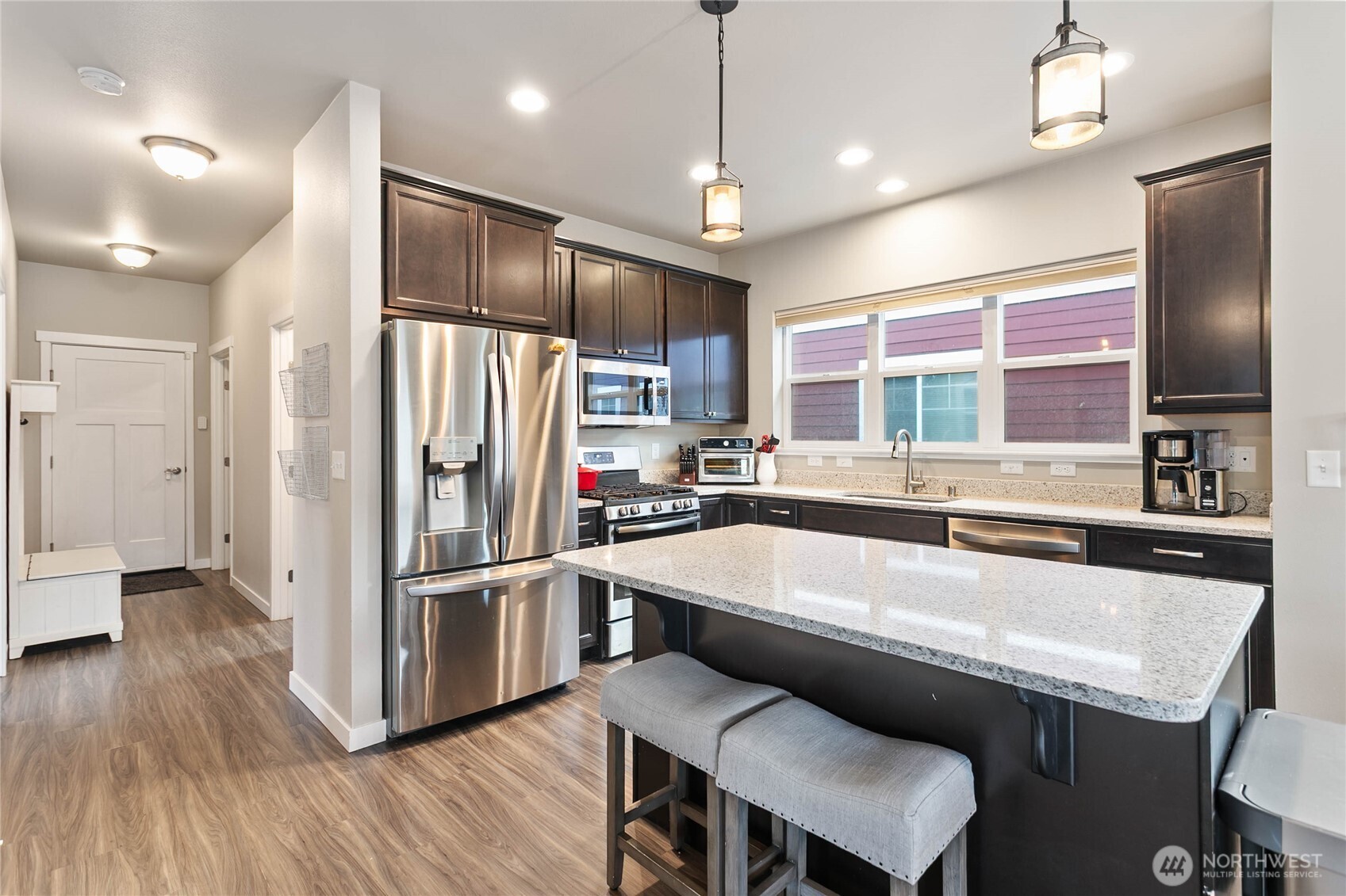 1970 North Prairie Lane Lynden, WA 98264 - Photo 16 of 40 a large kitchen with a table chairs refrigerator and microwave