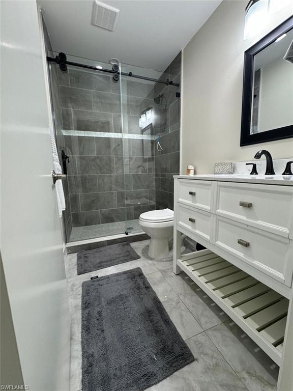 857 Palm View Drive, Unit 32 Naples, FL 34110 - Photo 6 of 9 a bathroom with a sink toilet and shower