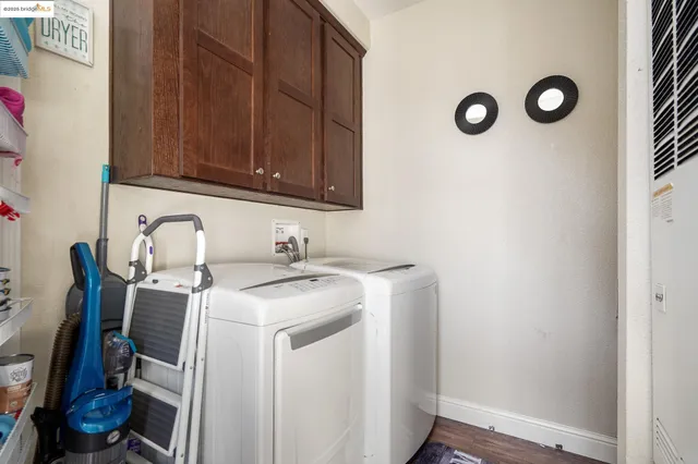 a kitchen with stainless steel appliances granite countertop a refrigerator a stove top oven and a sink with wooden floor