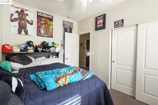 a bedroom that has a bed and a chair in it